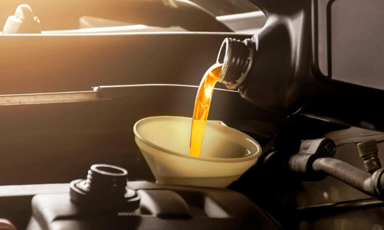 Service tech performing oil change